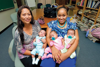 Latoya Elleby and her triplets Aysha, Daysha and Tysha sit with Latoya's nother, Mary Draper, left for a portrait Friday.  © 2011 Gallup Independent / Adron Gardner 
